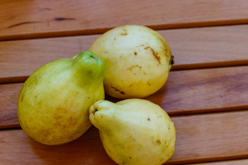 Whole guava fruits on wooden table