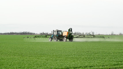 Tractor with a spray device for finely dispersed fertilizer.