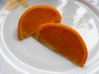 Naklejka na ściany i meble slices of orange on a plate
