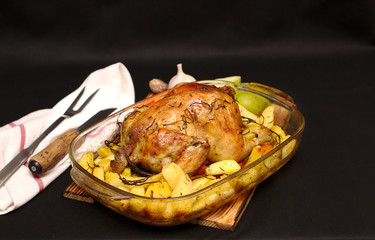 oven-baked crispy crust stuffed chicken on a plate with potatoes and apples
