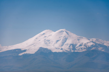 Fototapeta na wymiar View of the snow Elbrus in summer