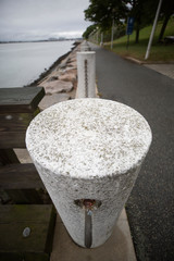 Stone Column and Chain Rail by Ocean Barrier Wall