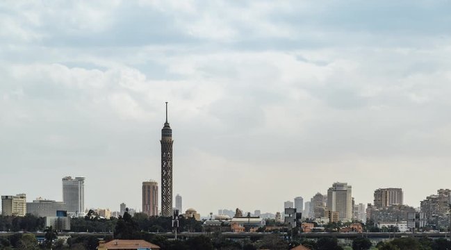 Timelapse of clouds passing over Cairo city center, with moving sun rays