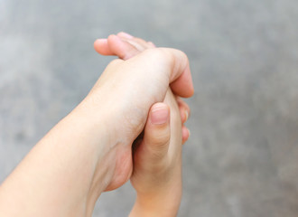 Adult Holding on to the Hand of a Child.
