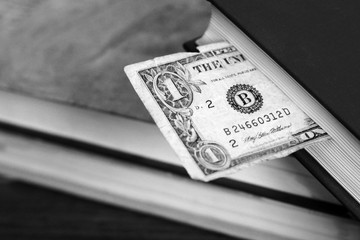 One dollar and book so close