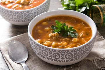 Harira soup in bowl on wooden table. Typical Moroccan food. Ramadán concept.
