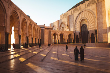 Fototapeta na wymiar people walking in hassan ii mosquepeople walking in hassan II mosque square - Casablanca, Morocco
