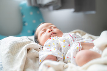 Adorable infant kid sleeping on blanket
