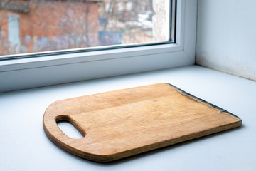 beautiful wooden board for cutting. kitchen board on a white background. kitchen board on the windowsill. start cooking