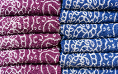 Folded terry towels on the counter of the store. Background towels.