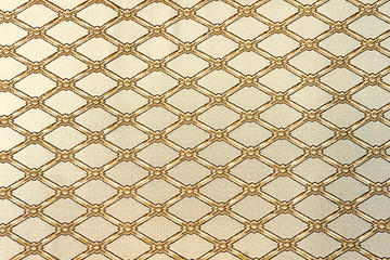 Diamond-shaped lattice on a beige background. Background for design and decoration.