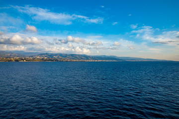 Obraz premium View of Strait of Messina connected Mediterranean and Tyrrhenian sea and Sicilia island background from ferry, Italy