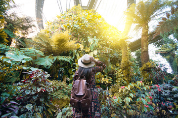 Tourist woman is traveling in the tropical forest jungle in Singapore.