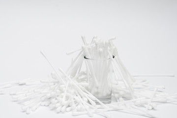Cotton swab in the glass with white paper background