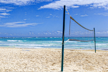 Volleyball net on a deserted sandy beach on the tropical sea.