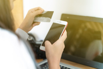 Business women using smartphone with credit card shopping online