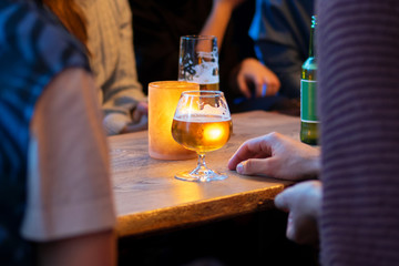 View on friends having alcoholic drinks in the bar, close-up