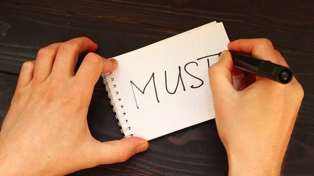 must Hands write a word close-up