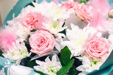 Beautiful and delicate bouquet of pink roses and white chrysanthemums