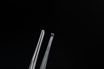 surgical clamp isolated on white surface