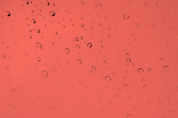 Monochrome blurred drops background.Rainy window.