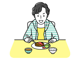 ハンバーグを食べる男子