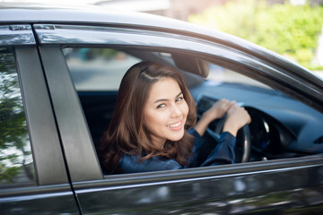 Fototapeta na wymiar Beautiful woman is driving her car