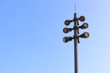 Street light LED with shade of sunlight on the pole blue sky background. 