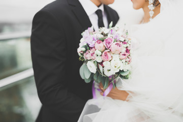 Bride holding big and beautiful wedding bouquet with flowers