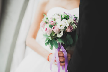 Obraz na płótnie Canvas Bride holding big and beautiful wedding bouquet with flowers