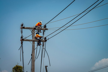 Electrician working on power pole