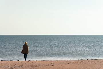 girl by the sea in calm sunny weather
