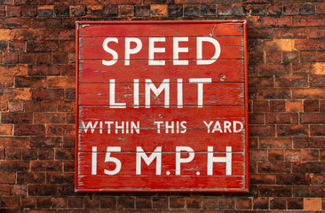 speed limit sign on brick wall