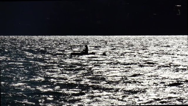 Lonely boat with a fisherman at night on the water