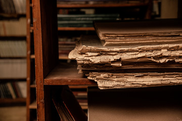 Vintage library, stach of old paper on wooden shelf, antique, closeup