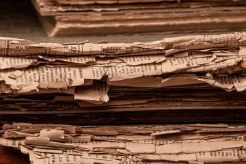 Stack of old papers on wooden shelf, paper texture, vintage background