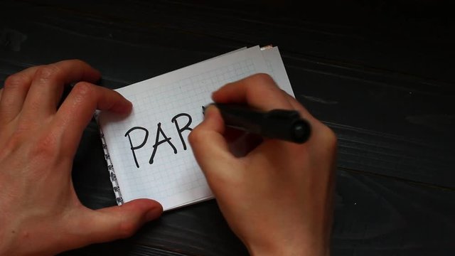Paris Hands write a word close-up