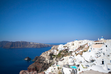 Fototapeta na wymiar Oia town on Santorini island, Greece. Traditional and famous white houses and churches with blue domes over the Caldera