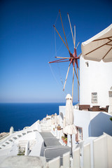 Oia town on Santorini island, Greece. Traditional and famous white houses and churches with blue domes over the Caldera