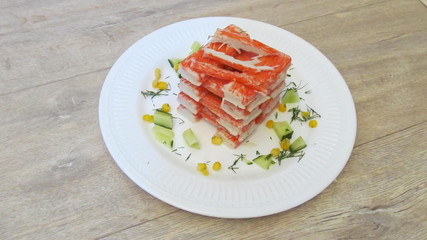 crab sticks on a white plate with the grey Desk     