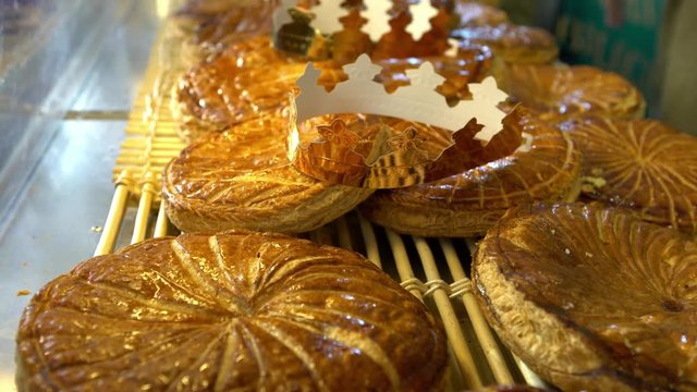 4K, Street market selling famous galette des rois. Traditional puff pastry cake with cardboard crown, sold and consumed during the first days of the year. It is often filled with frangipane cream.-Dan