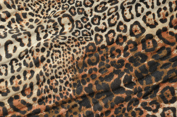 Fabric with leopard print. The image occupies the entire frame space. Close-up.