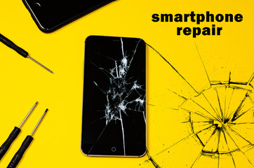 broken smartphone on a yellow background. copy cpace for text