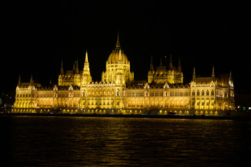 Fototapeta premium BUDAPEST, HUNGARY - MAR 07th, 2019: The Hungarian Parliament Building is the seat of the National Assembly of Hungary at the Danube river during night, one of Europe's oldest legislative buildings