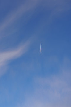 The airplane in the spring sky. Soft and calm image of nature, air and technology