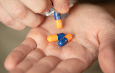 Colorful pills and medicines in the hand 
