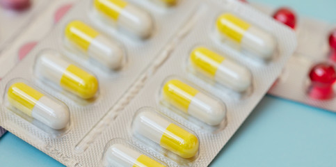 pharmaceuticals antibiotics pills medicine. Colorful antibacterials pills on blue background. Capsule pill medicine