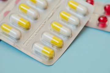 pharmaceuticals antibiotics pills medicine. Colorful antibacterials pills on blue background. Capsule pill medicine