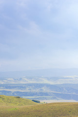 Overcast clouds in the distance over the hills