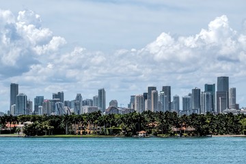 Fototapeta na wymiar View of the Miami Skyline with offices and Apartments with Biscayne bay and Star Island in the foreground